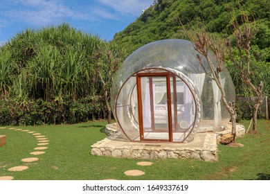 Romantic Bubble Hotel With Transparent Walls. White Wooden Double Bed With Mosquito Net Inside Bubble House. Honeymoon In An Inflatable Tent. Tourist Attraction In Tropical Paradise On Bali, Indonesia