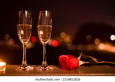 Romantic Candlelight Date Setting With Champagne Glasses And Red Rose. Valentines Day, And Date Night Concept. 