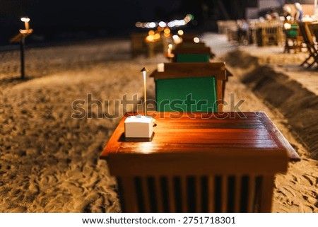 Romantic candlelight table setup on sandy beach at night Lamai Beach Koh Samui Thailand.