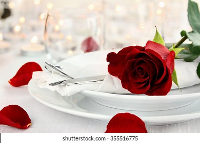 Romantic Candlelite Table Setting With Long Stem Red Rose. Shallow Depth Of Field With Selective Focus On Rose.