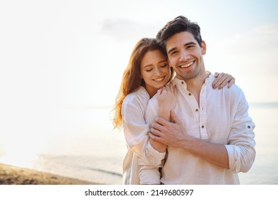 Romantic charming sunlit smiling happy young couple two friends family man woman in casual clothes hug each other at sunrise over sea beach ocean outdoor exotic seaside in summer day sunset evening - Powered by Shutterstock