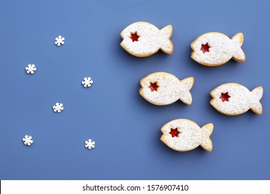Romantic concept with linzer cookies and small sugar snowflakes