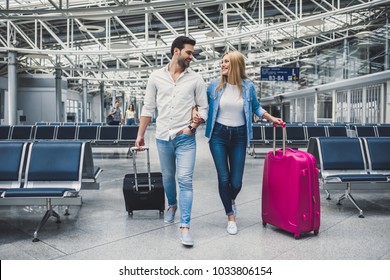 Romantic Couple In Airport. Attractive Young Woman And Handsome Man With Suitcases Are Ready For Traveling.