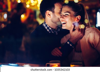 Romantic Couple Dating In Pub At Night