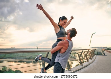 Romantic Couple Doing Sport Together On The Street. Having Fun After Morning Run