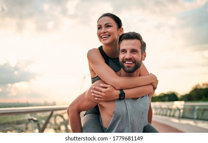 Romantic Couple Doing Sport Together On The Street. Having Fun After Morning Run