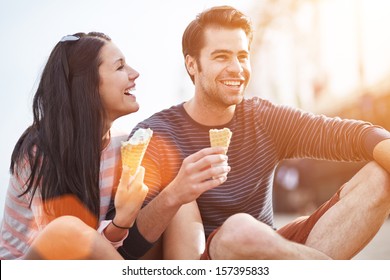 Romantic Couple Eating Ice Cream At Park