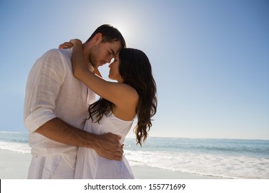 Romantic Couple Embracing  At The Beach