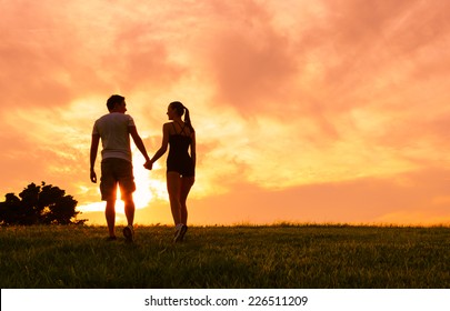 Romantic couple enjoying beautiful sunset in Hawaii