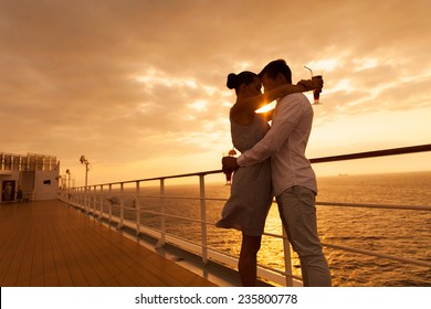 romantic couple hugging with eyes closed at sunset on a cruise ship - Powered by Shutterstock