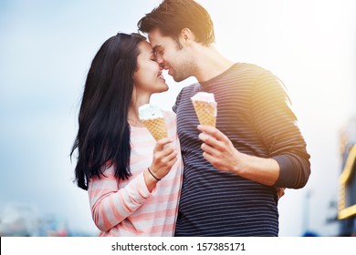 romantic couple with ice cream at amusement park - Powered by Shutterstock