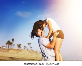 romantic couple in intimate moment on the beach.