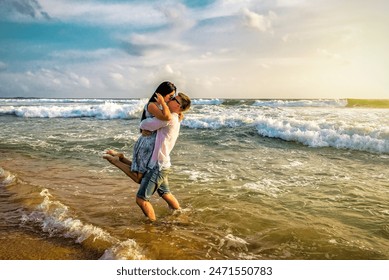 Romantic couple kissing in the ocean at beautiful tropical sunset - Powered by Shutterstock