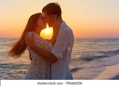 Romantic couple kissing on the beach - Powered by Shutterstock