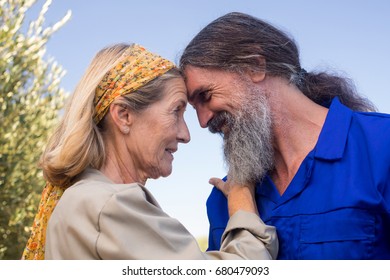 Romantic couple looking at each other in olive farm on a sunny day - Powered by Shutterstock