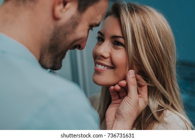 Romantic couple looking at each other and smiling.