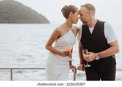 Romantic Couple Love Kissing On Yacht. Happy Man And Woman Standing And Kissing In Cruise Ship While Sunset On Vacation. Luxury And Honeymoon Lifestyle, Happy Aniversary.