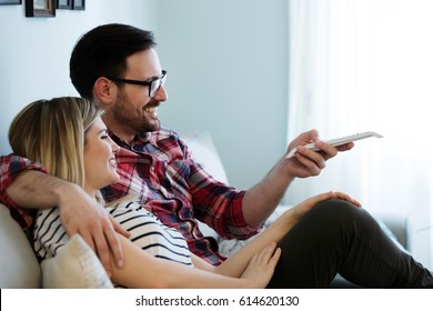 Romantic Couple In Love Watching TV At Home