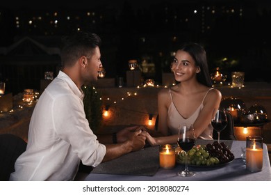 Romantic Couple On Cafe Terrace At Night