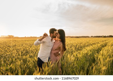 Romantic Couple on a Love Moment at gold wheat field - Holambra, Sao Paulo, Brazil - Powered by Shutterstock