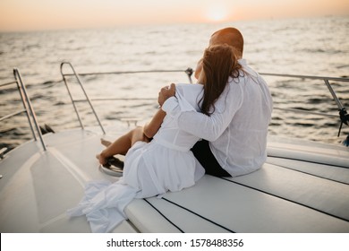 Romantic Couple On Yacht At Sunset, Young Couple Relaxing On The Yacht Cruise. Travel Adventure, Yachting Vacation.