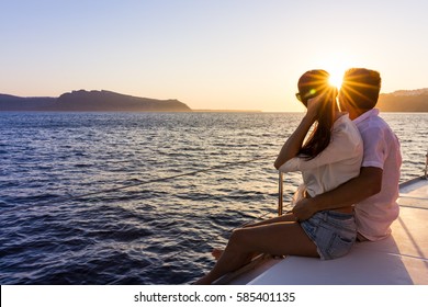 Romantic couple on yacht at sunset