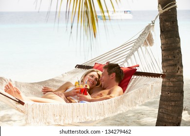 Romantic Couple Relaxing In Beach Hammock