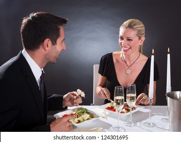Romantic couple sitting having dinner in an elegant restaurant