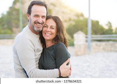 Romantic couple smiling and cuddling on a sunny day - Powered by Shutterstock