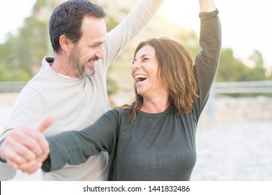 Romantic couple smiling and dancing on a sunny day - Powered by Shutterstock