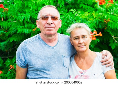Romantic Couple Smiling And Hugging On A Sunny Day. The Age Of The Man Is 60 Years Old. The Woman Is 55 Years Old. Mother And Father. 