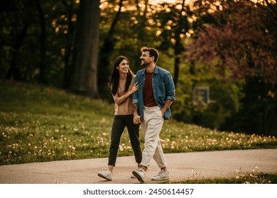 Romantic couple strolling hand in hand beneath a vibrant sunset - Powered by Shutterstock