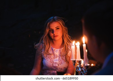 Romantic couple together over candlelight during romantic dinner outdoors