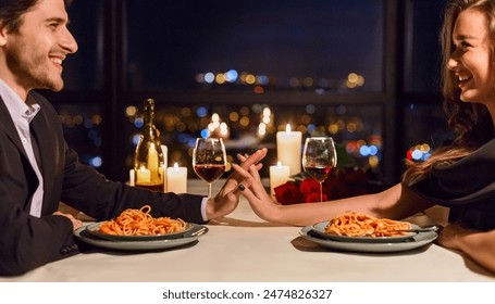 Romantic couple touching hands and smiling while having dating in restaurant. Happy evening together concept - Powered by Shutterstock