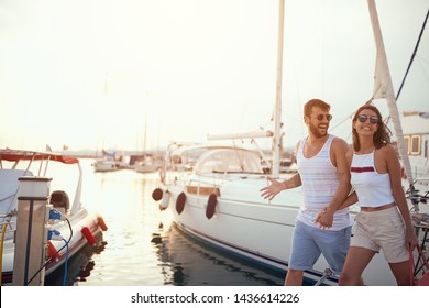 Romantic couple walking near the yachts on the dock.
 - Powered by Shutterstock