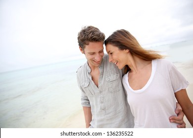 Romantic Couple Walking On The Beach