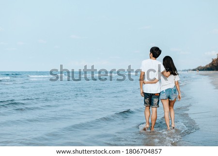 Romantic couple walking on beach. Man and woman in love.