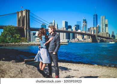 Romantic Couple Woman And Man With Beautiful  Brooklyn Bridge And Manhattan City Background. Happy Family Traveling In New York,USA 