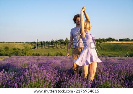 romantic dance partners in purple matching outfit, man and woman are dancing together in lavender field, love story, happy valentines day 