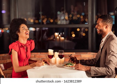 Romantic Date. Cheerful Couple Talking And Laughing Having Dinner In Fancy Restaurant Celebrating Valentine's Day