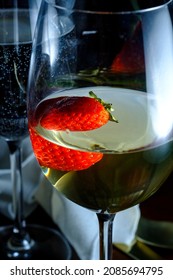 Romantic Date At Fancy Restaurant With Pinot Grigio White Wine With Strawberry Floating In Glass