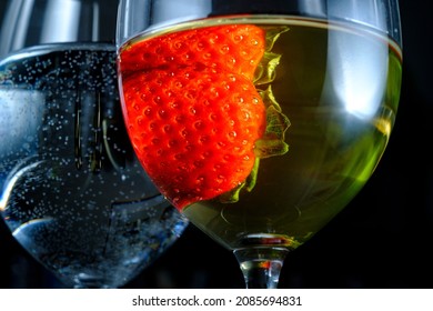 Romantic Date At Fancy Restaurant With Pinot Grigio White Wine With Strawberry Floating In Glass