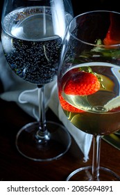 Romantic Date At Fancy Restaurant With Pinot Grigio White Wine With Strawberry Floating In Glass