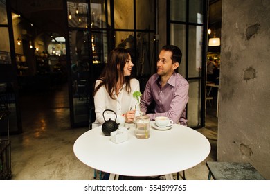 Romantic date. Happy couple in love in cafe on their date looking at each other and smiling. Love story.  - Shutterstock ID 554599765