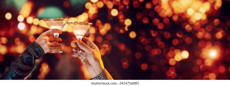 Romantic date. Mae and female hands clinking martini cocktails over bokeh background. Banner. Concept of holidays, celebration, events, Christmas, New Year, Valentines Day - Powered by Shutterstock