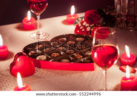 Romantic date night setting with box of chocolate's roses.  Valentine's Day gift concept. 