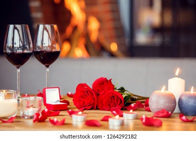 Romantic Date Objects In Restaurant Decorated Table With Bouquet Of Red Roses And Proposal Ring No People