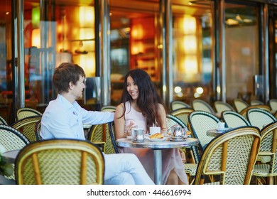 Romantic Dating Couple Drinking Coffee And Eating Traditional French Croissants In Cafe In Paris