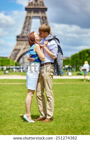 Romantic dating couple kissing in Paris near the Eiffel tower
