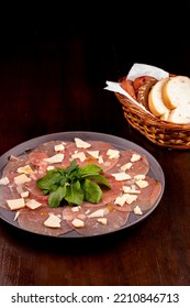 Romantic Dinner With Carpaccio Cold Meats Basket Of Artisan Breads Basil Leaves Wooden Table Top View Portrait